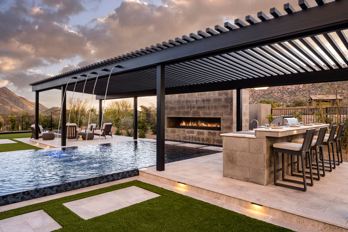 Luxurious backyard architecture with a gazebo, pool, fireplace, and outdoor kitchen