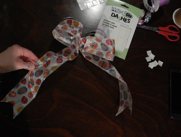 Peel back the liner of the UGluâ“‡ Dash and affix your loops right on either side. Use those ties to place bow perfectly onto your package! Viola!