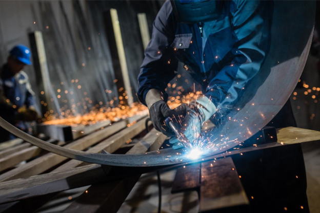 Using certified ATEX tools - Male welders in a workshop using special welding tools. Using certified ATEX tools - Male welders in a workshop using special welding tools.