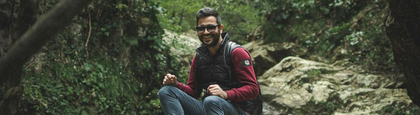 Man wearing glasses in forest