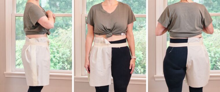 Front, side and rear view of shorts muslin attached to temporary waistband that has been pulled up, creating a shorter crotch curve