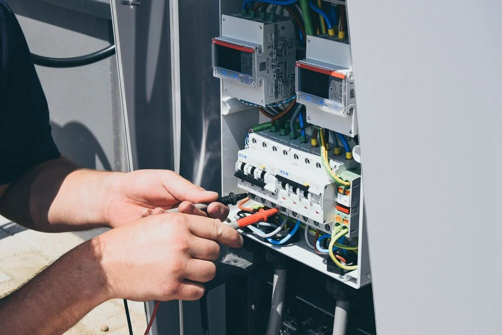 A close-up of someone repairing an EVBox charging station.