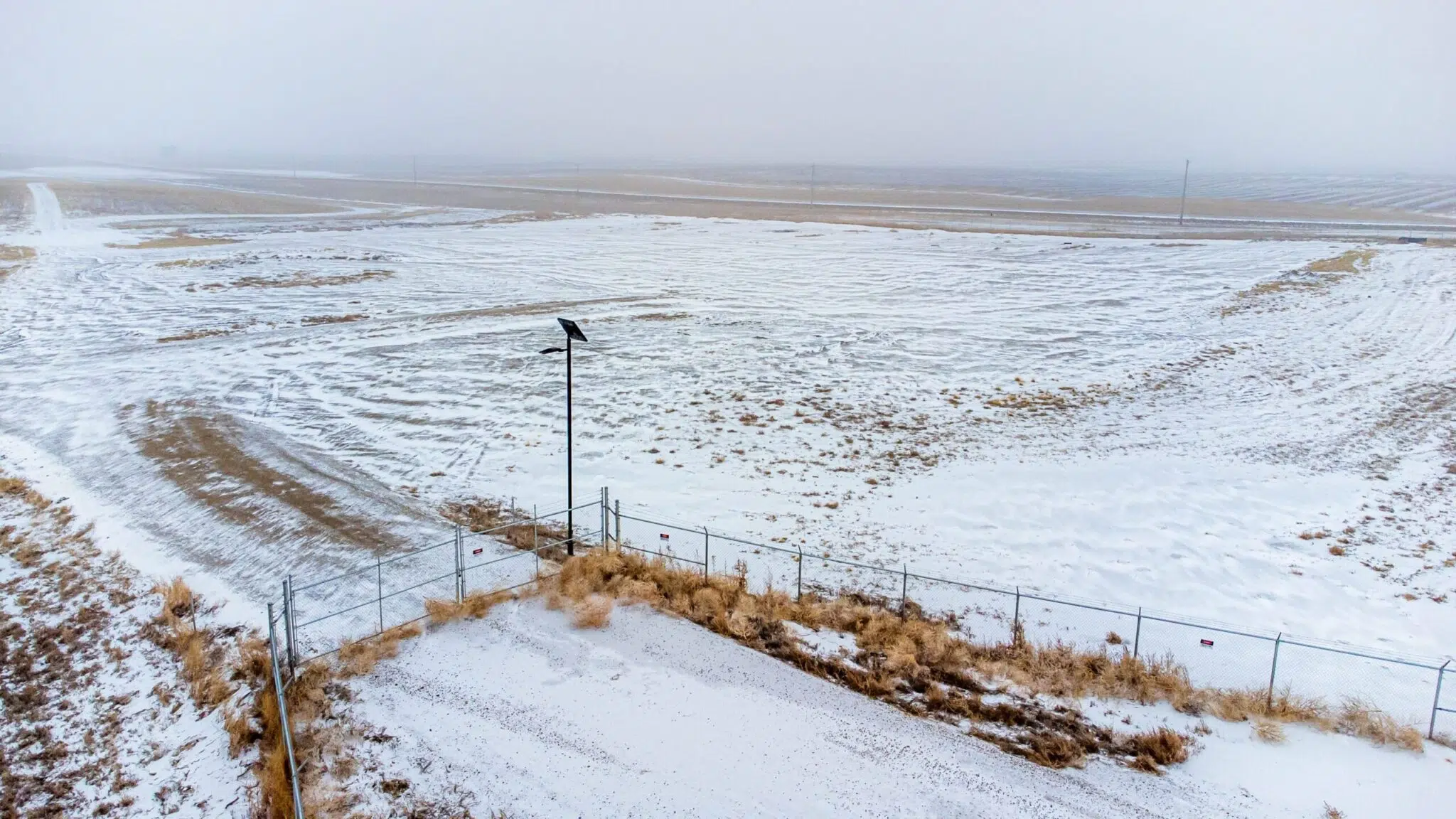 solar light at a gate access point in the snow