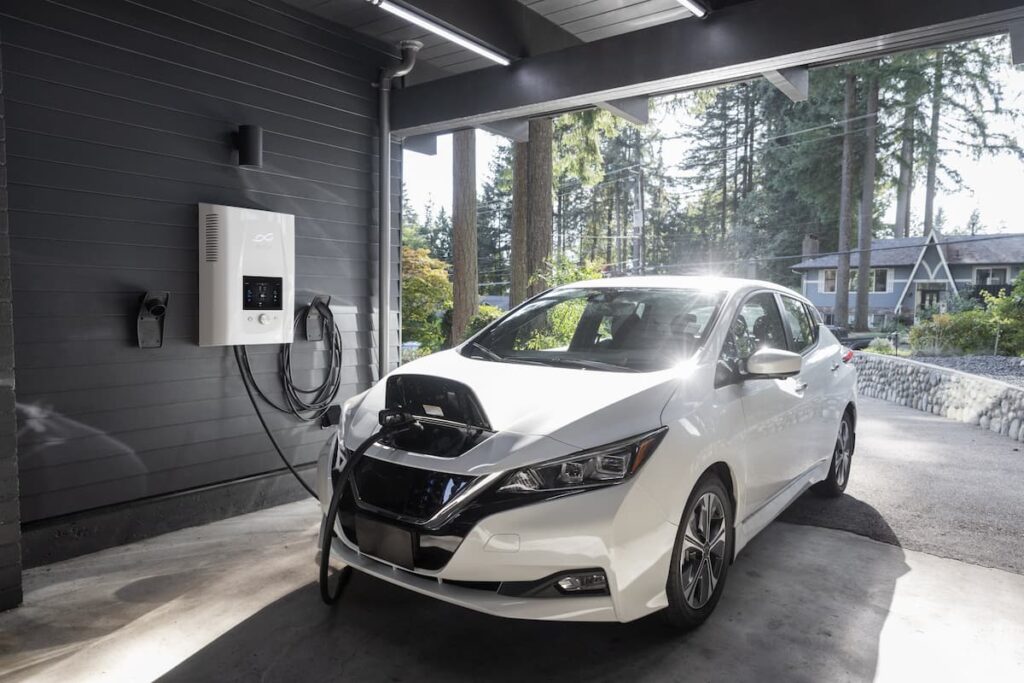 White electric car charging in a garage