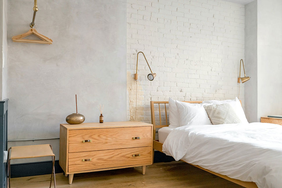pale wood bed and bedside table in chic room