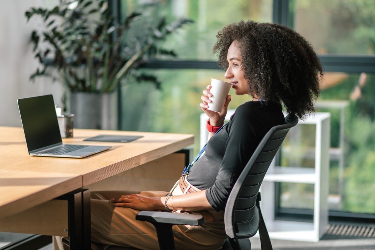 Woman relaxing at a modern office desk.