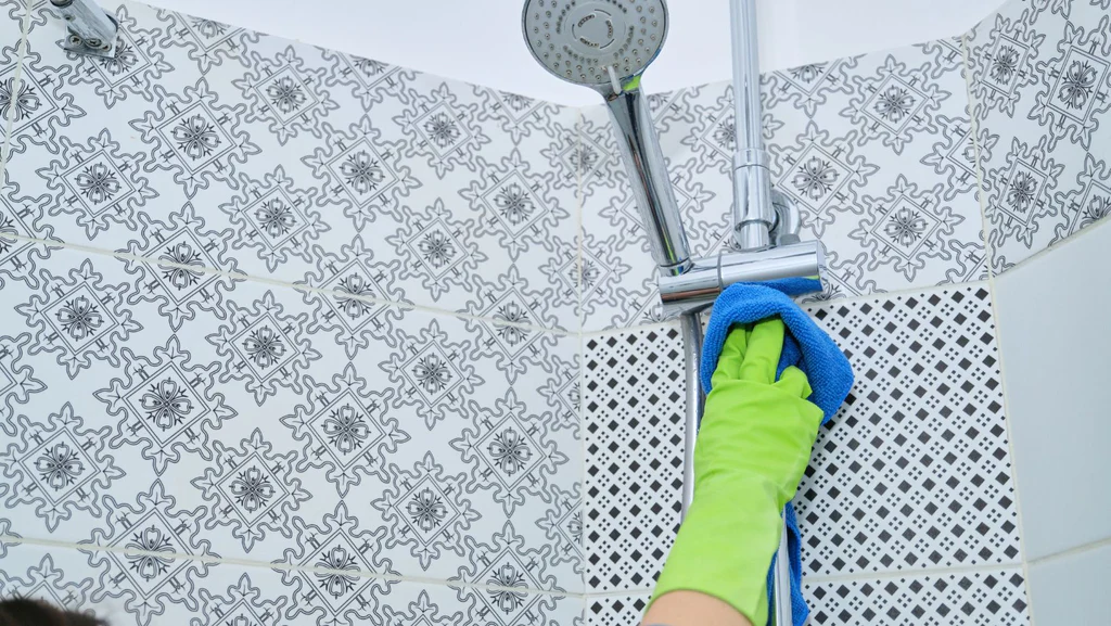 A person cleaning the shower