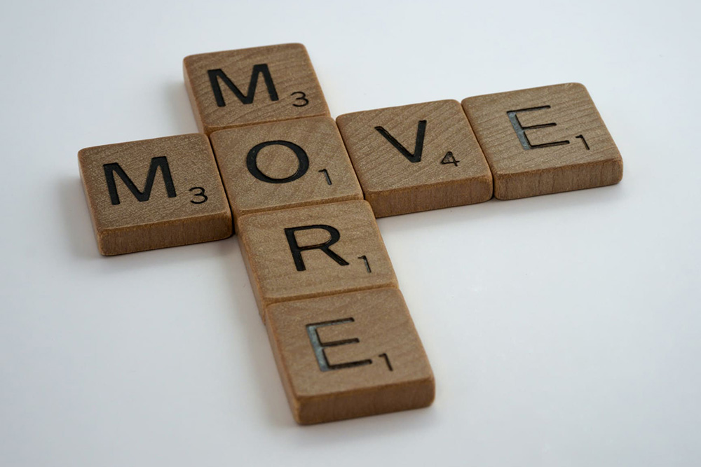 Scrabble tiles spelling 'Move More'