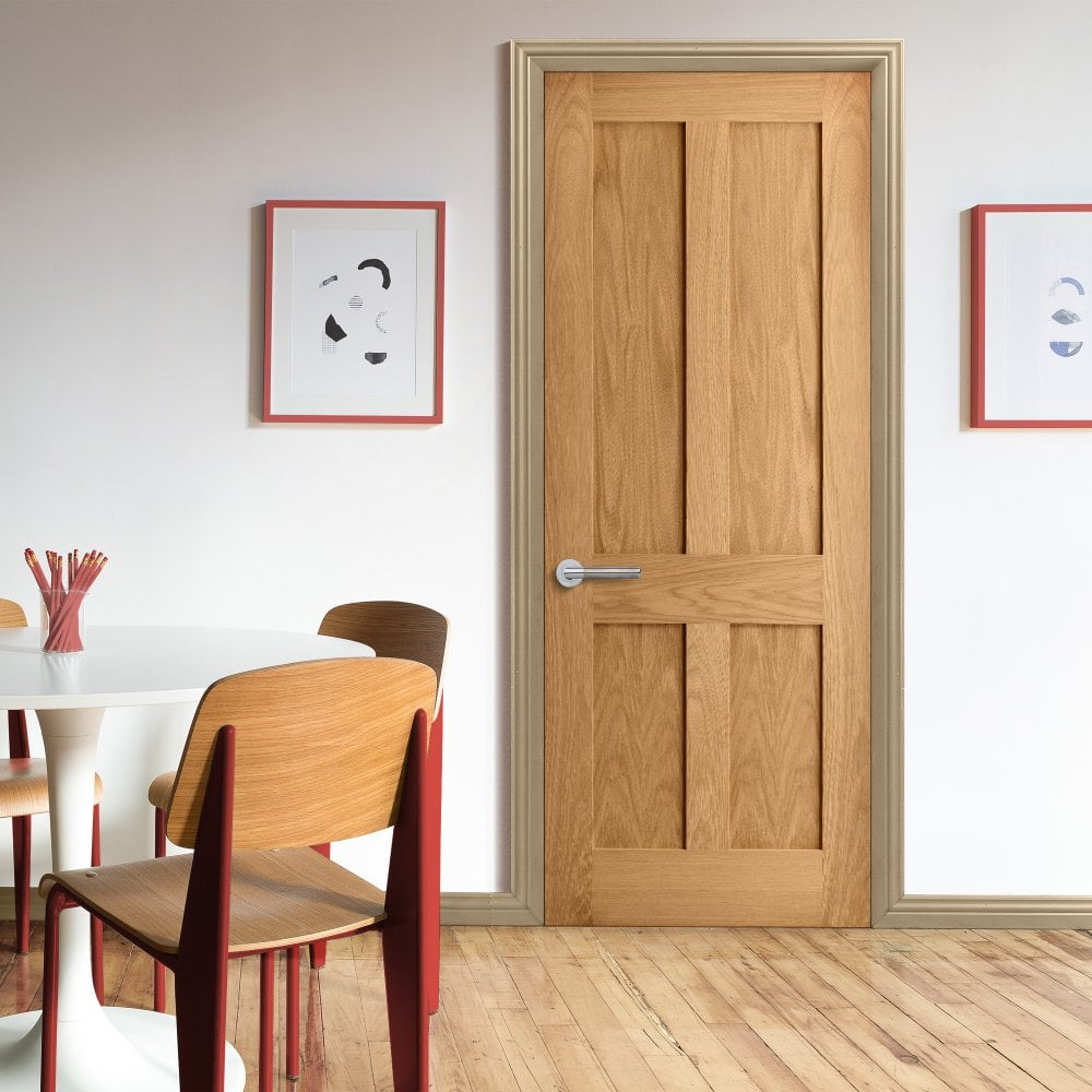 A brown panelled fire door with a silver handle in a gold frame.
