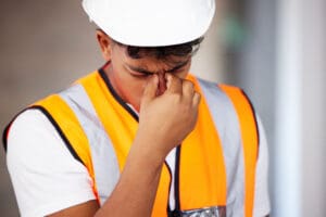 Young worker with headache related to heat stroke