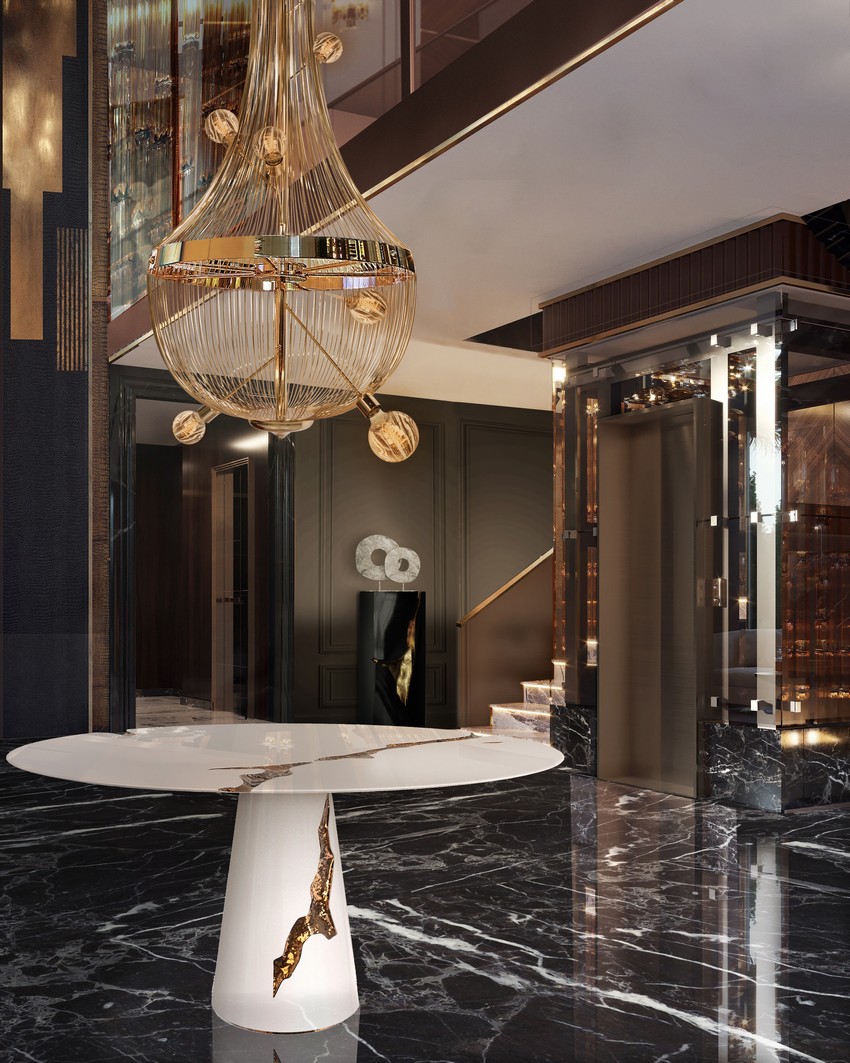 modern classic entryway with a golden chandelier and a marble table