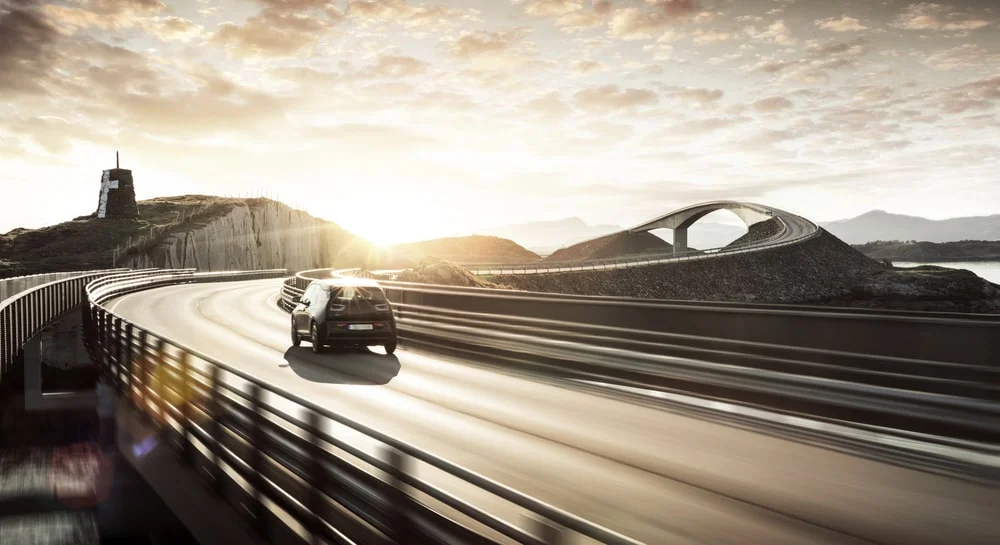 Electric car driving on an empty highway.