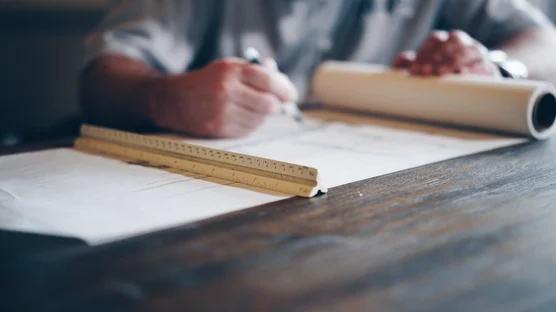 An analysis of a workplace location being mapped out on a blueprint.