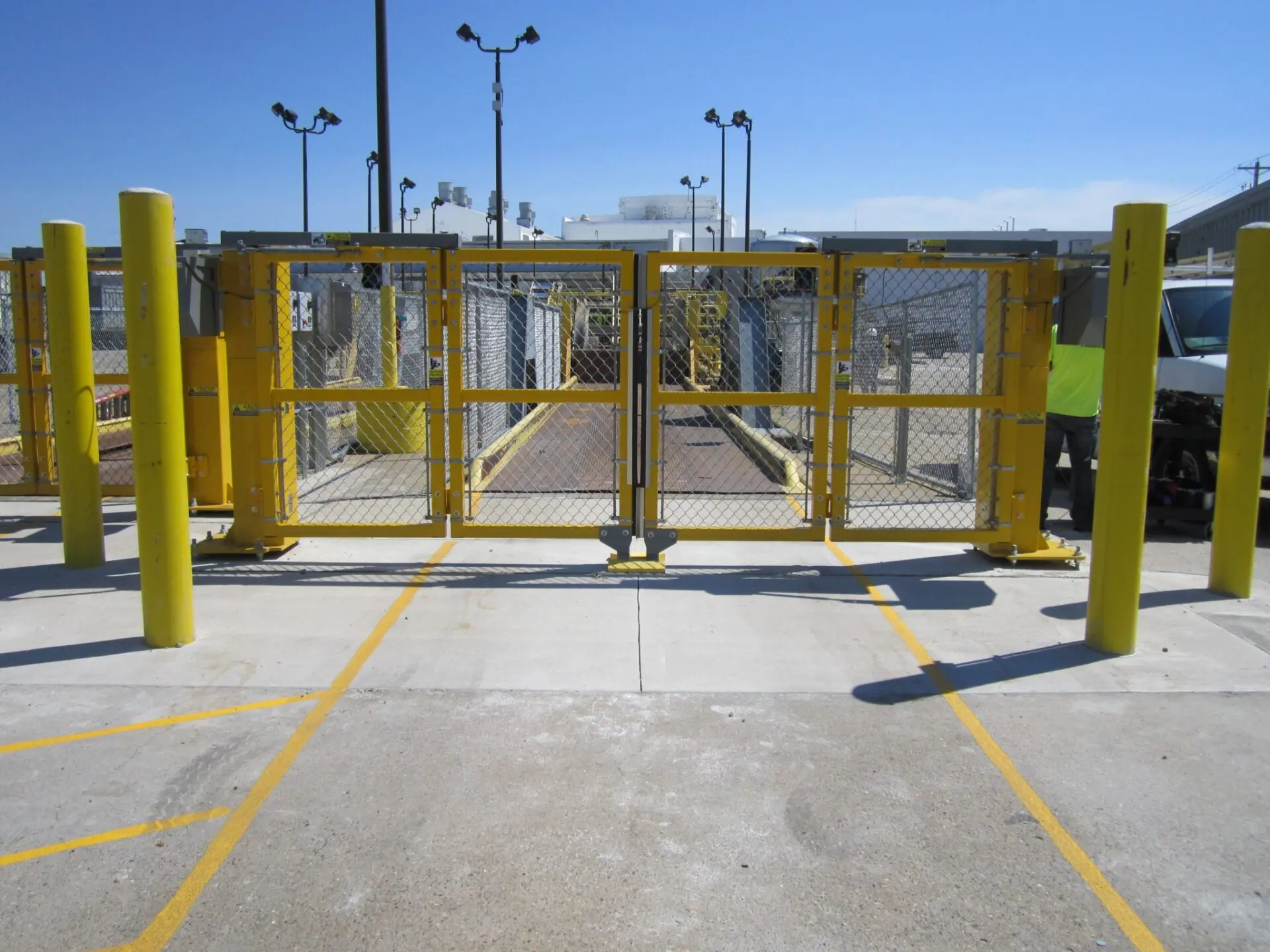 yellow chain link bi-folding security gate