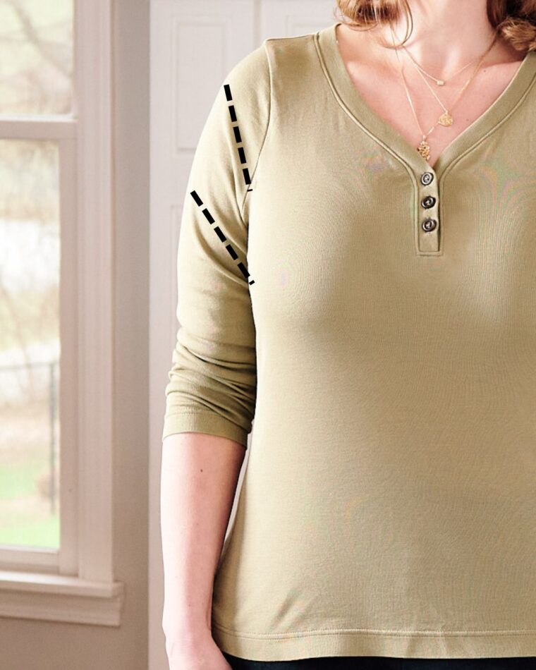 A close-up view of a shirt sleeve showing drag lines. Dashed black lines have been drawn on the sleeve to demonstrate.