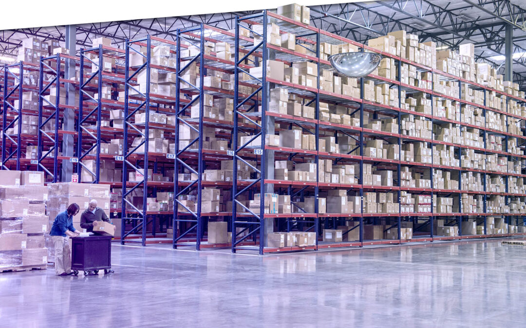 Two employees checking inventory in temporary storage in a distribution warehouse.