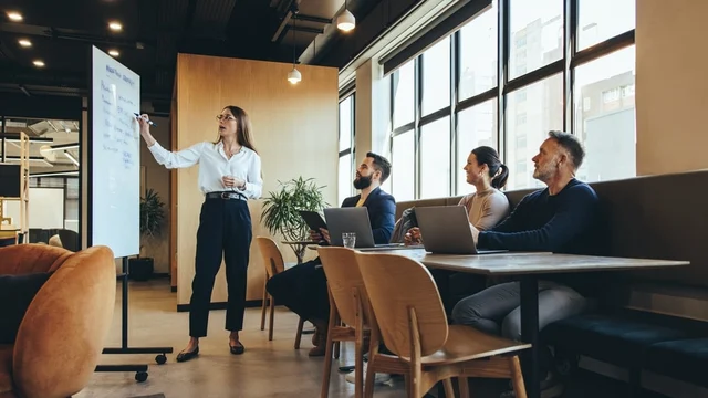 A woman giving a engaging presentation to her peers.