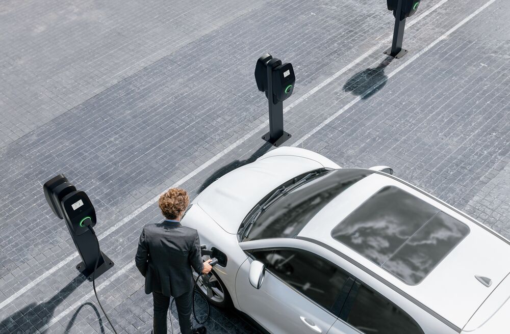 Man using EVBox Liviqo charging station.