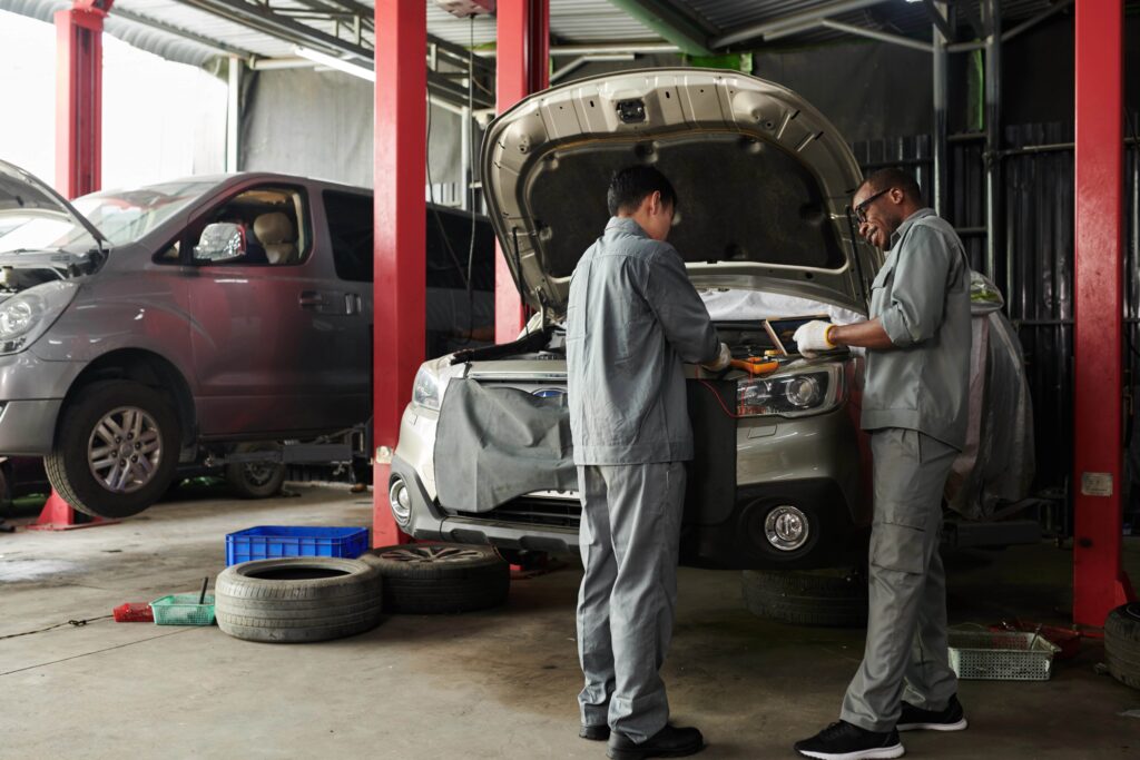 Mechanics working on a car for a tune-up service