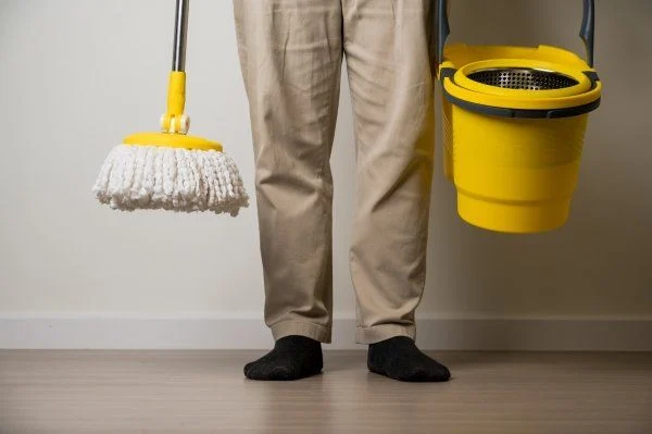 Man Standing with Mop and Bucket