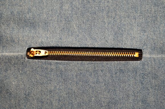 exposed zippers on welt pockets