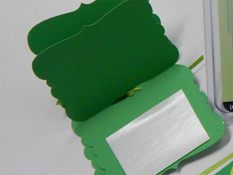 Start by cutting card stock to form the main folding tag.
