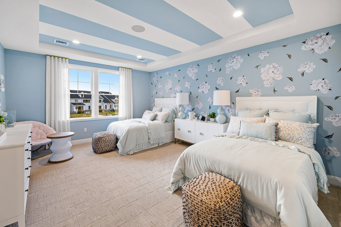 Kids’ bedroom with a light blue color scheme and floral wallpaper