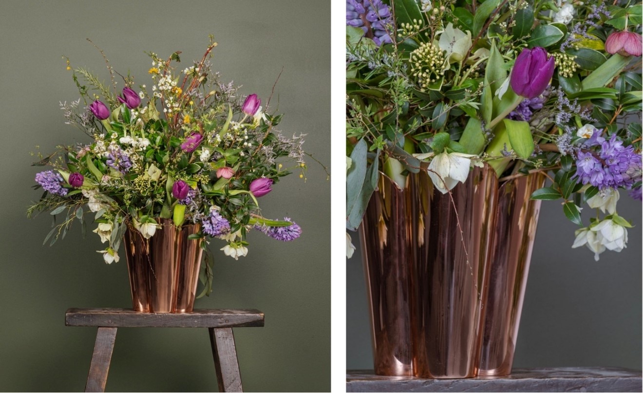 Our large Smooth Copper Flora plant pot with a bright bouquet of flowers.