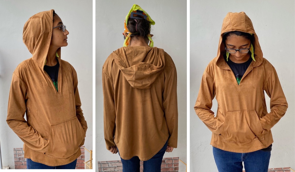 girl wearing tan hooded pullover stop with kangaroo front pocket