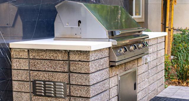a vent for a patio grill on a custom built grill island