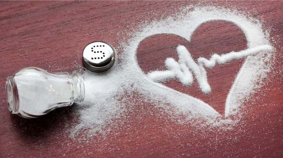 Sodium Salt vs. Potassium Chloride: Finding the Healthier Balance salt shaker spilt with a heart rate image drawn in the spilt salt