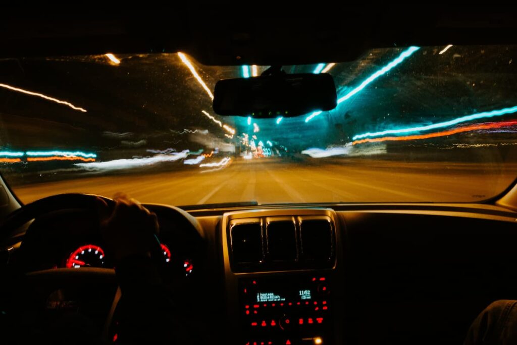 An autonomous vehicle cruising down a darkened highway.