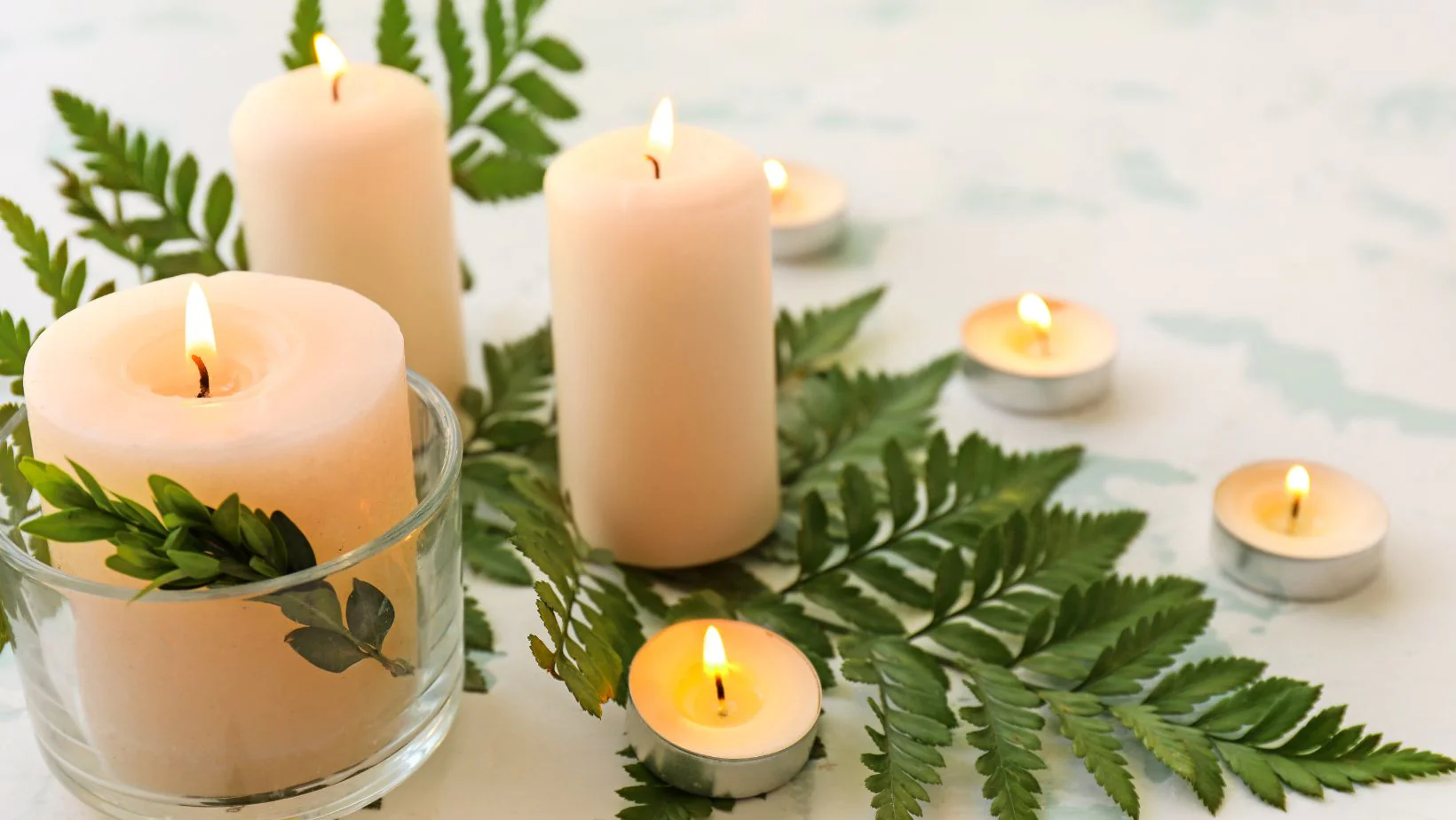 Decorative candles on ferns