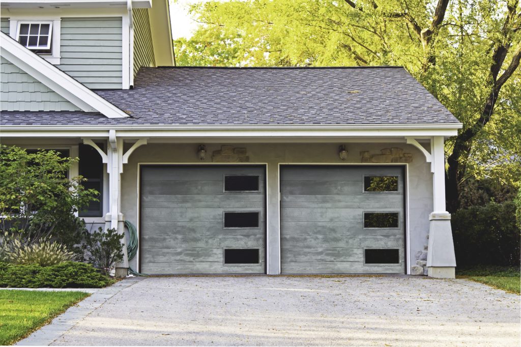 A double garage door with windows on the right side