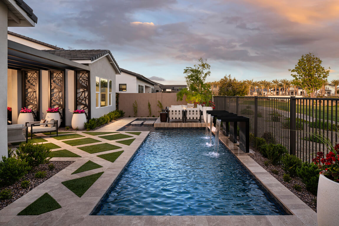 Luxurious backyard design with a pool and waterfall