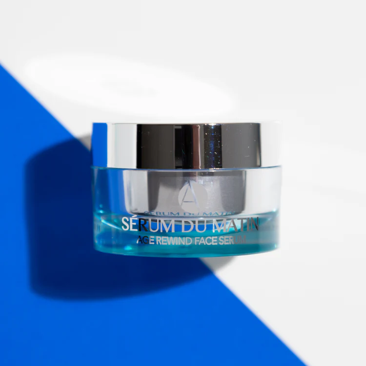 ANJALI MD Age Rewind Face Serum casting a shadow on a blue background