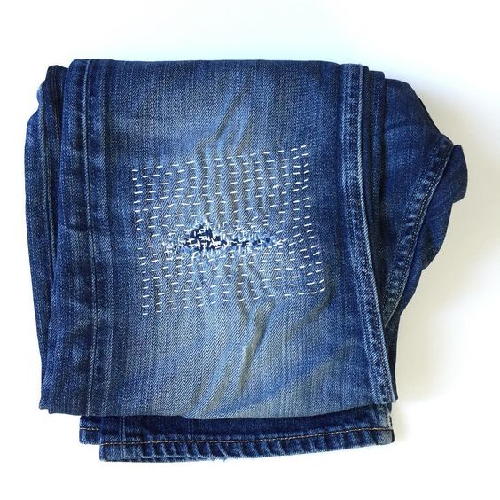 Visible mending with Sashiko stitching on jeans