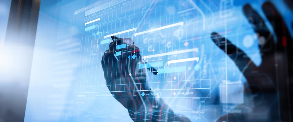 A futuristic image of hands interacting with a transparent screen.