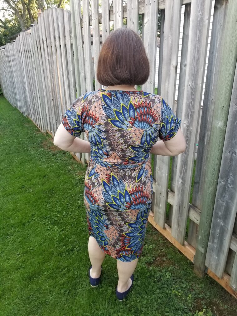 Back view of Woman standing in back yard wearing handmade dress