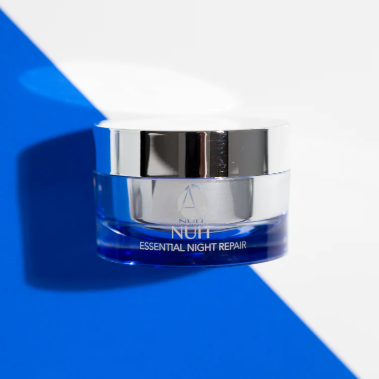 ANJALI MD Brightening Retinol Night Cream casting a shadow on a blue background