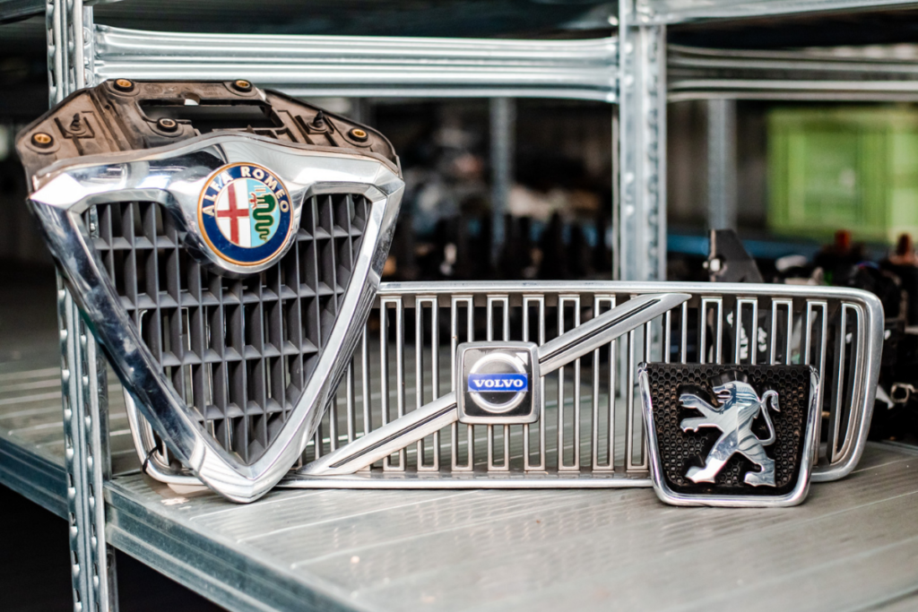 Three different front grilles displayed on a shelf