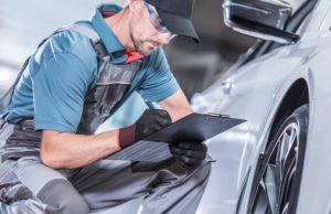 car mechanic inspecting vehicle