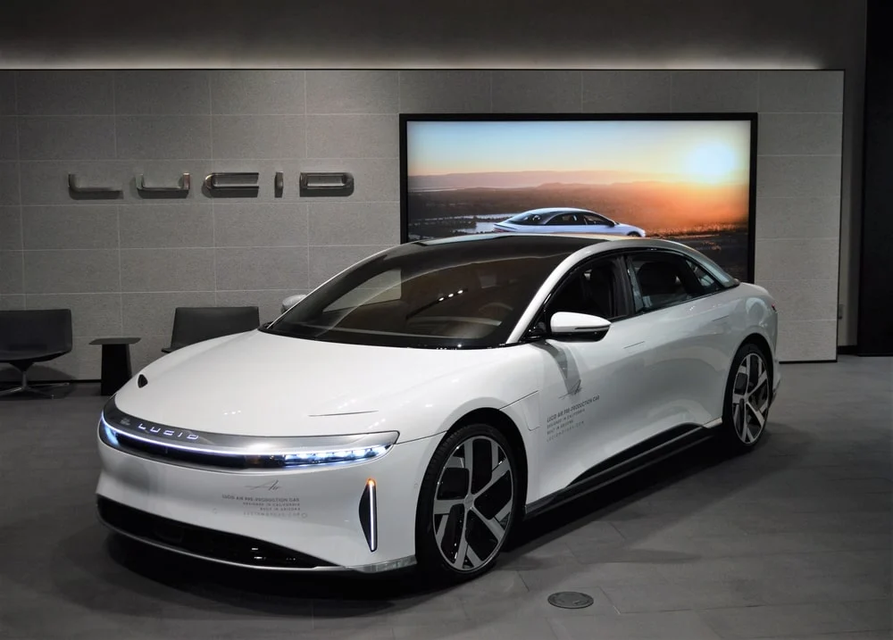 A white Lucid Air Dream parked at a trade show.