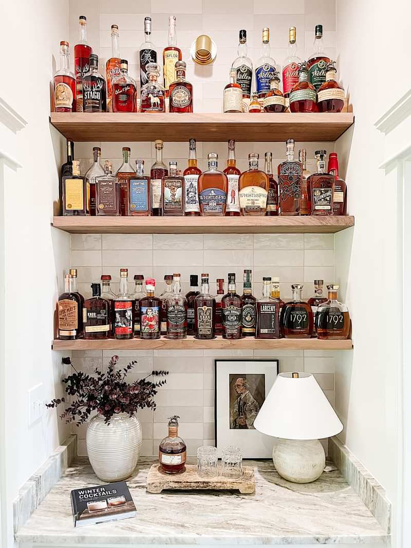 A bourbon collection takes pride of place adjacent to the kitchen and living room