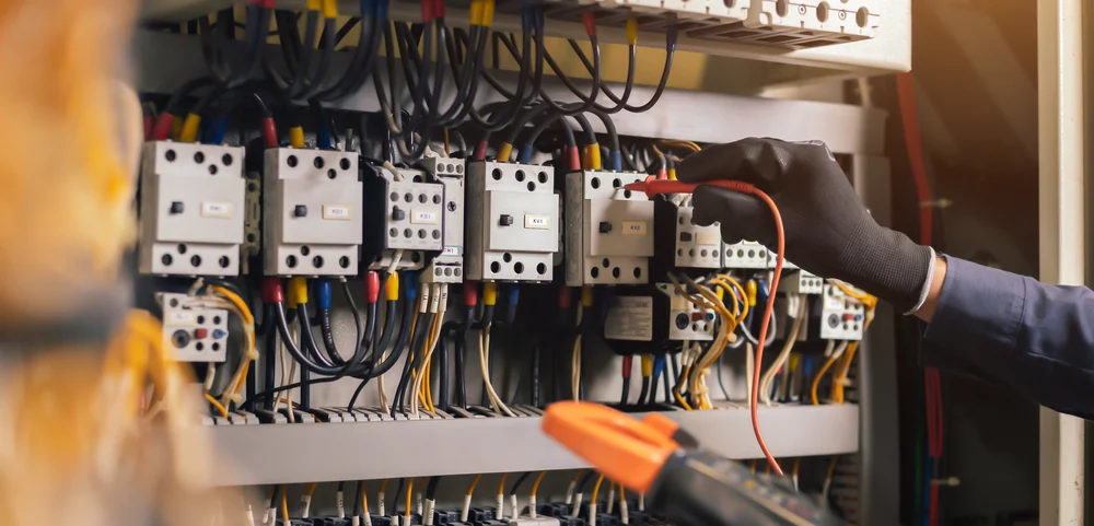 A closeup of a person working with electric wiring.