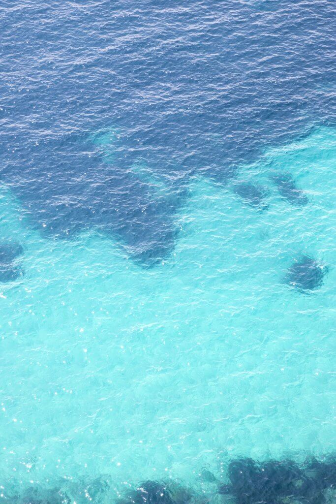 Looking down at the turquoise Mediterranean water from the Basse Corniche, France, by Cattie Coyle Photography