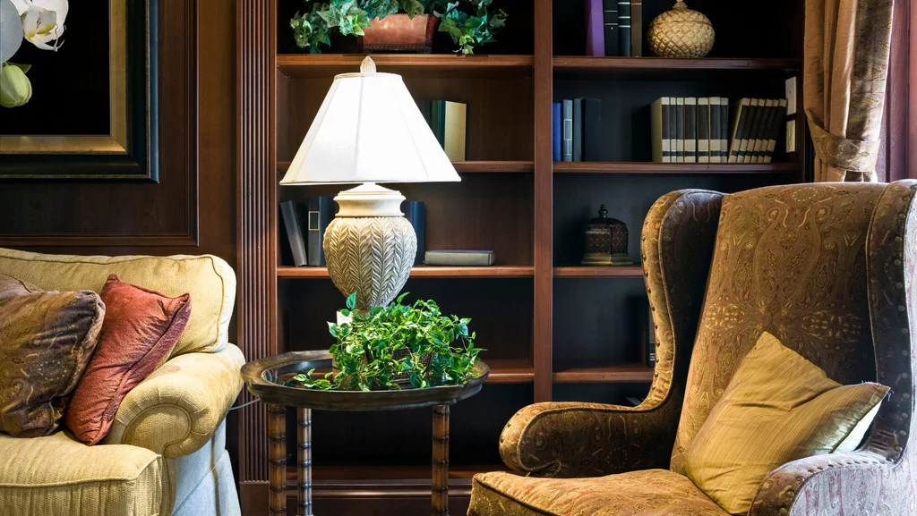 A reading space with a sofa and a library