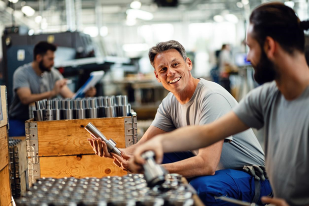 Using ATEX tools for worker protection - Male welders in a manufacturing company assessing steel rods.. Using ATEX tools for worker protection - Male welders in a manufacturing company assessing steel rods.