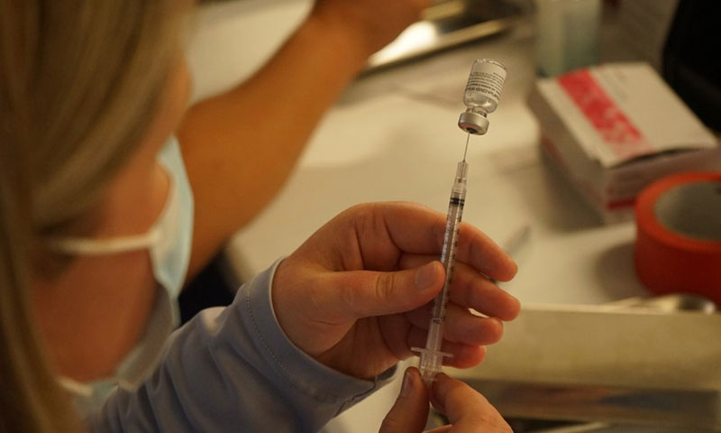 A medical worker prepares a dose of COVID-19 vaccine at the Universal Studios Hollywood in Los Angeles, California, the United States, June 18, 2021.