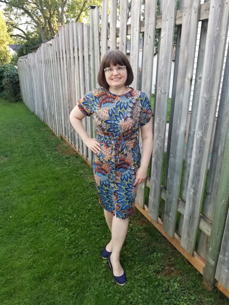 Woman standing in back yard wearing handmade dress